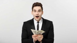 man in suit holding cash