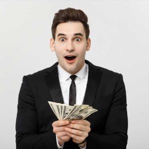 man in suit holding cash