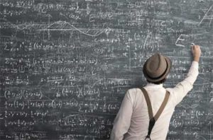 man doing calculations on chalkboard