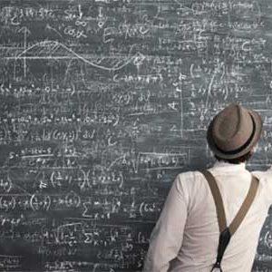 man doing calculations on chalkboard